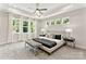 Spacious main bedroom boasts a tray ceiling, multiple windows, and a seating bench for a relaxing retreat at 1645 Carolina Cir, Gastonia, NC 28054