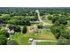 Expansive aerial view of property with green spaces, nearby roads, and water tower in the distance at 1730 Woodbend Ln, Conover, NC 28613