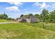 View of the back of the home showing the yard, deck and home exterior on a sunny day at 1730 Woodbend Ln, Conover, NC 28613