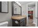 Bathroom with granite counters, dark cabinetry, and a view through the doorway into the kitchen at 1730 Woodbend Ln, Conover, NC 28613