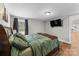 Comfortable bedroom featuring wood floors, a mounted TV, and soothing natural light at 1730 Woodbend Ln, Conover, NC 28613