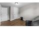 Simple bedroom featuring a clean design, wood floors, and ample closet space at 1730 Woodbend Ln, Conover, NC 28613