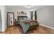 Cozy bedroom with wood floors, decorative bedding, and natural light from the window at 1730 Woodbend Ln, Conover, NC 28613