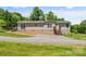 Cozy single-story home with a well-maintained yard, complemented by a wooden deck and charming landscaping at 1730 Woodbend Ln, Conover, NC 28613