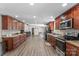 Spacious kitchen featuring wood cabinets, granite counters, stainless steel appliances and hardwood floors at 1730 Woodbend Ln, Conover, NC 28613