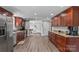 Spacious kitchen showcasing wood cabinets, granite counters, stainless steel appliances and hardwood floors at 1730 Woodbend Ln, Conover, NC 28613