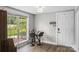Bright kitchen nook with glass table, gray bar stools, a large window, and a view of lush greenery at 1730 Woodbend Ln, Conover, NC 28613