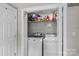 Convenient laundry closet with washer, dryer, and shelving for storage and organization at 1730 Woodbend Ln, Conover, NC 28613