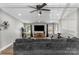 Inviting living room featuring a ceiling fan, flat screen TV, and comfortable gray sofa at 1730 Woodbend Ln, Conover, NC 28613