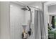 Modern shower featuring a rainfall shower head, tiled walls, and a convenient corner shelf at 1730 Woodbend Ln, Conover, NC 28613