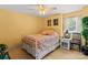Charming bedroom featuring a white iron bed frame, wood floors, and sunny yellow walls at 20417 Harborgate Ct # 510, Cornelius, NC 28031