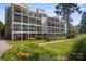 Exterior view of multi-story condo building, showcasing patios and lush green surroundings at 20417 Harborgate Ct # 510, Cornelius, NC 28031