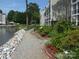 Lakeside walking path with decorative rocks and lush landscaping, perfect for serene strolls and relaxation at 20417 Harborgate Ct # 510, Cornelius, NC 28031