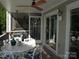Inviting screened porch with a ceiling fan and a white table set for outdoor dining and relaxation at 20417 Harborgate Ct # 510, Cornelius, NC 28031
