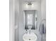 Charming powder room with pedestal sink, modern lighting, and neutral color scheme at 2108 Bryant Park Dr, Charlotte, NC 28208