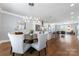 Open-concept dining area with stylish chandelier, hardwood floors, and view of the kitchen at 2108 Bryant Park Dr, Charlotte, NC 28208