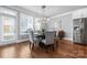 Bright dining room features a modern chandelier, hardwood floors, and large windows at 2108 Bryant Park Dr, Charlotte, NC 28208