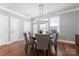 Elegant dining room with large windows, modern chandelier, and seating for five at 2108 Bryant Park Dr, Charlotte, NC 28208