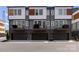Modern townhome featuring a gray exterior, private balconies, and attached garages at 2108 Bryant Park Dr, Charlotte, NC 28208