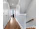 Upstairs hallway features wood floors and neutral walls, leading to bedrooms and other living spaces at 2108 Bryant Park Dr, Charlotte, NC 28208