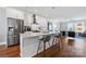 Modern kitchen with stainless steel appliances, white cabinets, and a breakfast bar at 2108 Bryant Park Dr, Charlotte, NC 28208
