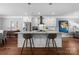 Kitchen island with a breakfast bar featuring white cabinets and stainless steel appliances at 2108 Bryant Park Dr, Charlotte, NC 28208