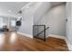Inviting interior with hardwood floors, modern railing, and ample lighting at 2108 Bryant Park Dr, Charlotte, NC 28208