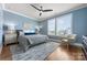 A main bedroom with a large window featuring a ceiling fan, carpet, and a view of the city skyline at 2108 Bryant Park Dr, Charlotte, NC 28208