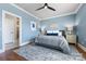 The main bedroom showcases a calming blue palette, a ceiling fan, and an ensuite bathroom at 2108 Bryant Park Dr, Charlotte, NC 28208