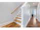 Beautiful wooden staircase with wood floors and white trim leading to the upper level at 2108 Bryant Park Dr, Charlotte, NC 28208