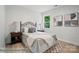 Cozy bedroom with a metal frame bed, wood nightstands, warm lamps, geometric rug, and artful wall decor at 2116A Glenwood St, Kannapolis, NC 28083