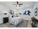 This bedroom has neutral paint, light hardwood floors, ceiling fan, a large window, and gray area rug at 2116A Glenwood St, Kannapolis, NC 28083