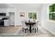 Charming dining area with natural light, a modern black table, and views into the kitchen at 2116A Glenwood St, Kannapolis, NC 28083