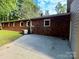 Brick home features a concrete patio and landscaping for outdoor enjoyment at 2130 Vashti Rd, Taylorsville, NC 28681