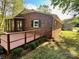 Brick home featuring a stained back deck with wooden railings and manicured landscaping, next to backyard at 2130 Vashti Rd, Taylorsville, NC 28681