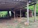 Open barn structure showcasing wooden beams, offering ample space for various rural or agricultural purposes at 2130 Vashti Rd, Taylorsville, NC 28681