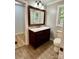 Bathroom featuring dark vanity, marble countertop, wood look flooring, and natural light at 2130 Vashti Rd, Taylorsville, NC 28681