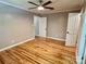 A bedroom with hardwood floors, ceiling fan, closet, and multiple doorways at 2130 Vashti Rd, Taylorsville, NC 28681
