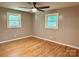 A bedroom featuring hardwood floors, ceiling fan, and natural light from two windows at 2130 Vashti Rd, Taylorsville, NC 28681