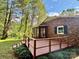 Charming brick home featuring a spacious deck, screened porch, and a serene wooded backdrop at 2130 Vashti Rd, Taylorsville, NC 28681