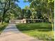 Charming single-story home with a lush front lawn and long driveway leading to an attached garage at 2130 Vashti Rd, Taylorsville, NC 28681
