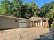 Brick home features a spacious driveway leading to a detached garage at 2130 Vashti Rd, Taylorsville, NC 28681
