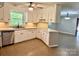 Functional kitchen with neutral countertops and cabinetry, updated appliances, and a view to the living spaces at 2130 Vashti Rd, Taylorsville, NC 28681