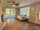 Comfortable living room with a brick fireplace, ceiling fan and natural light at 2130 Vashti Rd, Taylorsville, NC 28681