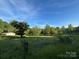 Lush greenery surrounds a home with a gated entrance, offering privacy and serenity at 2130 Vashti Rd, Taylorsville, NC 28681