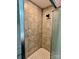 Shower with beige tile walls and white hexagon tile floor and clear glass door at 2130 Vashti Rd, Taylorsville, NC 28681