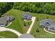 Expansive aerial view showcases landscaped lawns and neighborhood with mature trees at 224 Hidden Meadows Dr, Mooresville, NC 28117