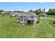 Aerial backyard view features a lawn, patio seating area, and screened-in porch at 224 Hidden Meadows Dr, Mooresville, NC 28117