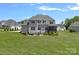 Backyard features a patio area with an umbrella, screened-in porch, and plenty of green space at 224 Hidden Meadows Dr, Mooresville, NC 28117