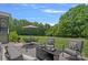 Relaxing backyard with outdoor seating, dining area, and beautiful green lawn surrounded by mature trees at 224 Hidden Meadows Dr, Mooresville, NC 28117